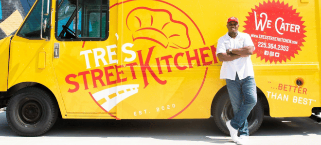 food truck entrepreneur in front of his food truck